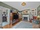 Living room with fireplace, built-in shelving, and a view into an adjacent room at 603 S Fulton St, Salisbury, NC 28144