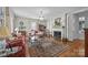 Bright living room featuring a fireplace, chandelier, hardwood floors, and classic furnishings at 603 S Fulton St, Salisbury, NC 28144
