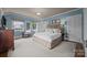 Spacious main bedroom with natural light, a large bed, and serene decor at 603 S Fulton St, Salisbury, NC 28144