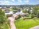 View of estate home with landscaped lawn, private pond, brick exterior, and lake access at 6823 Manatee Dr, Concord, NC 28025