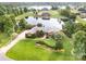 Expansive estate home with a well-manicured lawn, brick exterior and private pond with lake access at 6823 Manatee Dr, Concord, NC 28025