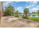 Expansive patio overlooking a serene lake, complete with palm trees and lush greenery at 6823 Manatee Dr, Concord, NC 28025
