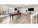 Spacious basement featuring a pool table, entertainment area, and plenty of natural light from the large window at 6823 Manatee Dr, Concord, NC 28025