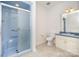 Bright bathroom featuring blue trim, a glass door shower, and neutral tile floors at 6823 Manatee Dr, Concord, NC 28025