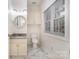Compact bathroom featuring vanity with granite countertop and decorative mirror at 6823 Manatee Dr, Concord, NC 28025