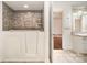 Modern bathroom featuring a walk-in tub with mosaic tile surround, heated towel rack and vanity at 6823 Manatee Dr, Concord, NC 28025