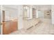 Bathroom vanity with double sinks, walk-in shower, soaking tub, and tile flooring at 6823 Manatee Dr, Concord, NC 28025