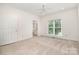 Bright bedroom with neutral carpet, a large window, and an attached bathroom at 6823 Manatee Dr, Concord, NC 28025