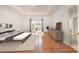 Bright bedroom featuring hardwood floors, a tray ceiling, and large windows that fill the room with plenty of natural light at 6823 Manatee Dr, Concord, NC 28025