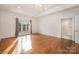 Large main bedroom showcasing tray ceiling, hardwood floors, and lake views at 6823 Manatee Dr, Concord, NC 28025