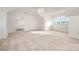 Large bonus room or loft with carpet, vaulted ceilings, fan, and lots of light at 6823 Manatee Dr, Concord, NC 28025