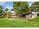 Stately brick home boasts lush landscaping, elegant entryway, and mature trees at 6823 Manatee Dr, Concord, NC 28025