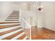 Bright foyer with hardwood staircase and floors, and chandelier lighting at 6823 Manatee Dr, Concord, NC 28025