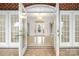 Grand foyer entrance with double glass doors and a decorative chandelier at 6823 Manatee Dr, Concord, NC 28025