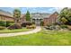 Beautiful brick home with a well-manicured lawn, decorative water feature, and lush landscaping at 6823 Manatee Dr, Concord, NC 28025