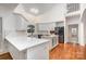 Modern kitchen with white cabinets, island, stainless steel appliances, and soaring ceilings at 6823 Manatee Dr, Concord, NC 28025