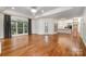 Open-concept living space with hardwood floors, large windows, and an open kitchen at 6823 Manatee Dr, Concord, NC 28025