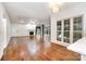 Expansive living room with hardwood floors, cozy fireplace, and large windows with lake views at 6823 Manatee Dr, Concord, NC 28025