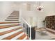 Open concept living room features a staircase, hardwood floors, and natural light at 6823 Manatee Dr, Concord, NC 28025