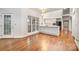 Bright room with hardwood floors, a kitchen island, and access to an outdoor space at 6823 Manatee Dr, Concord, NC 28025
