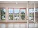 Bright sunroom featuring picturesque lake views through large windows and a tile floor at 6823 Manatee Dr, Concord, NC 28025