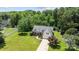 Aerial view of a home showcasing its manicured lawn, mature trees, and inviting curb appeal at 6908 Beamish Pl, Mint Hill, NC 28227