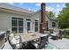 Spacious backyard patio includes a table and chairs and a grill at 6908 Beamish Pl, Mint Hill, NC 28227