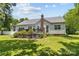 Spacious backyard features a well-manicured lawn, a deck, and privacy from mature trees, ideal for outdoor enjoyment at 6908 Beamish Pl, Mint Hill, NC 28227