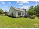 Lovely backyard featuring a well-maintained lawn, a deck, and mature trees, perfect for outdoor enjoyment at 6908 Beamish Pl, Mint Hill, NC 28227
