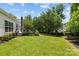 Expansive backyard showcases lush green grass and a deck, providing ample space for outdoor activities and relaxation at 6908 Beamish Pl, Mint Hill, NC 28227
