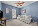 A comfortable bedroom features neutral carpet, blue walls, and a ceiling fan at 6908 Beamish Pl, Mint Hill, NC 28227
