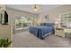 Bedroom with large window, ceiling fan, and blue bedding at 6908 Beamish Pl, Mint Hill, NC 28227