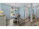 Cozy dining area with chandelier, hardwood floors, and natural light at 6908 Beamish Pl, Mint Hill, NC 28227