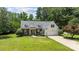A beautifully maintained home with mature landscaping, a two-car garage, and a welcoming entrance at 6908 Beamish Pl, Mint Hill, NC 28227