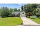Charming home with a well-manicured lawn, mature trees, and a welcoming driveway, showcasing curb appeal at 6908 Beamish Pl, Mint Hill, NC 28227