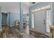Stylish foyer with hardwood floors, light blue walls and an adjacent dining area at 6908 Beamish Pl, Mint Hill, NC 28227