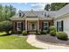 Inviting front exterior with brick accents, manicured landscaping, and a welcoming entryway creates a warm ambiance at 6908 Beamish Pl, Mint Hill, NC 28227