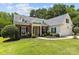 Charming brick home features a manicured lawn, black shutters, and dormer windows, all contributing to a welcoming curb appeal at 6908 Beamish Pl, Mint Hill, NC 28227