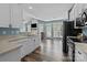 Kitchen view to the living room featuring stainless appliances and wood floors at 6908 Beamish Pl, Mint Hill, NC 28227