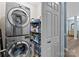 A laundry room features a stacked washer and dryer, shelving, and storage at 6908 Beamish Pl, Mint Hill, NC 28227