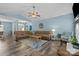 Open living space featuring hardwood floors, high ceilings, and seamless flow between seating and dining areas at 6908 Beamish Pl, Mint Hill, NC 28227