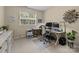 A well lit home office with dual monitors, desk, chair, and storage at 6908 Beamish Pl, Mint Hill, NC 28227