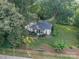 An aerial view shows lush landscaping surrounding a charming home with a meticulously maintained lawn at 7901 Bud Henderson Rd, Huntersville, NC 28078