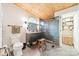 Bright bathroom features a glass enclosed shower, tiled floor, wooden ceiling, and modern vanity at 7901 Bud Henderson Rd, Huntersville, NC 28078