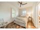 Cozy bedroom with hardwood floors, neutral colors, and two windows providing natural light at 7901 Bud Henderson Rd, Huntersville, NC 28078