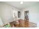 Bright bedroom with hardwood floors, an easel, and access to another room at 7901 Bud Henderson Rd, Huntersville, NC 28078