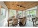 Bright dining area featuring a wood ceiling, ample natural light, tile floors, and access to the backyard at 7901 Bud Henderson Rd, Huntersville, NC 28078