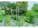 A well-maintained garden features raised beds, trellises and a gate for easy entry and exit at 7901 Bud Henderson Rd, Huntersville, NC 28078