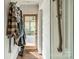 Entry hallway with coat racks, wood floors, and a view to the porch at 7901 Bud Henderson Rd, Huntersville, NC 28078