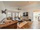 Bright living room featuring hardwood floors, neutral paint, a ceiling fan, and large windows with plantation shutters at 7901 Bud Henderson Rd, Huntersville, NC 28078